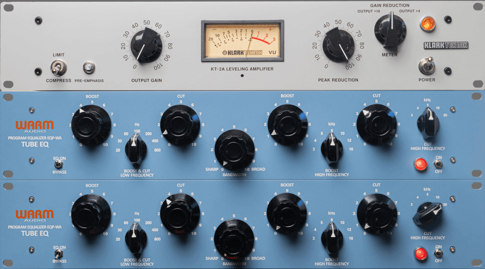 A rack of hardware LA2A compressors and warm audio EQs